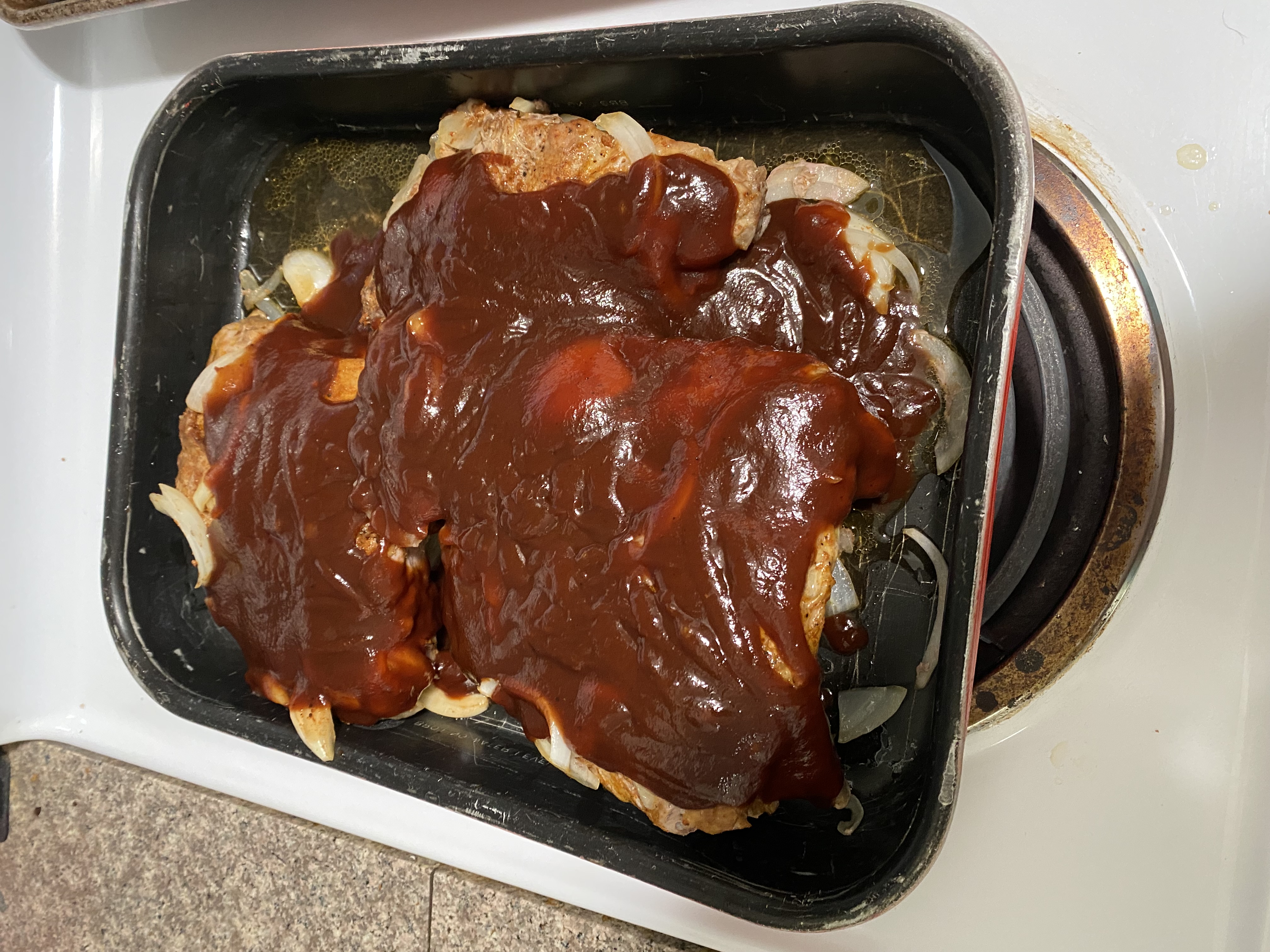 Ribs out of the oven after baking with BBQ sauce